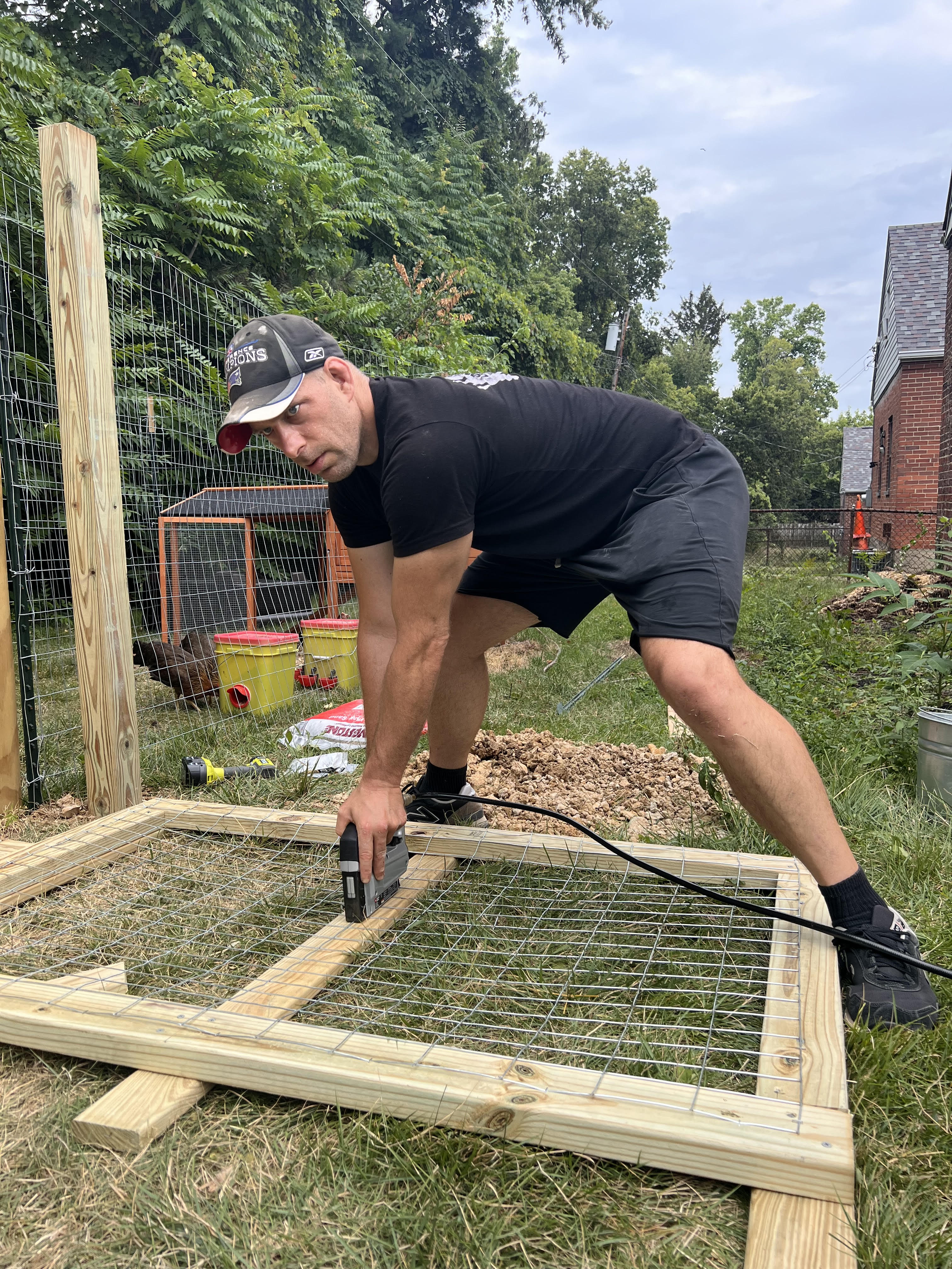 Eric building a wooden frame outdoors.
